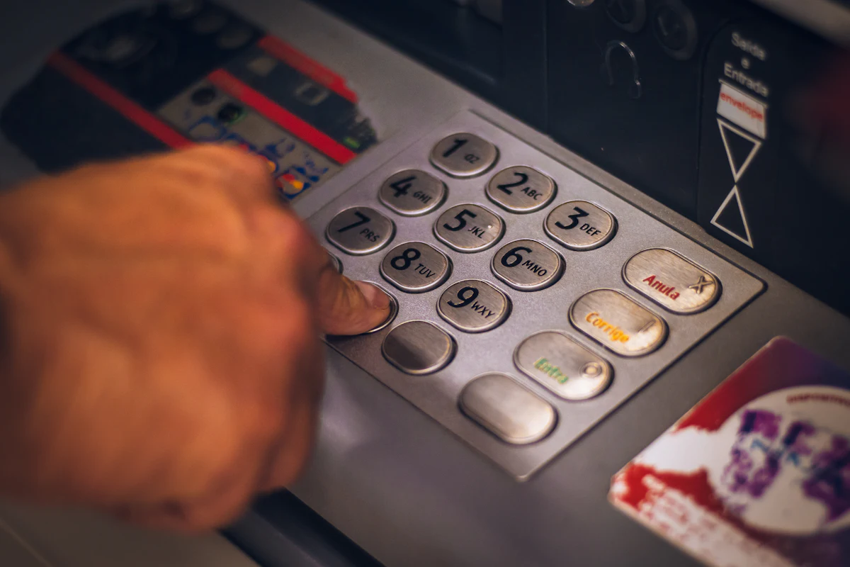 Hand entering a PIN on a card payment keypad