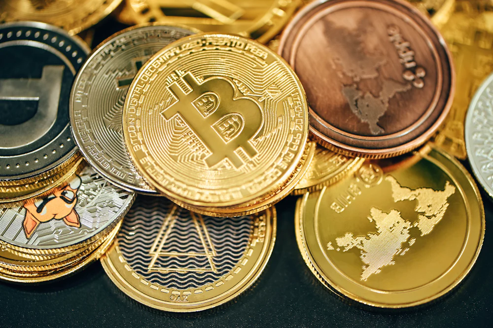 Close-up of a physical Bitcoin coin resting on a dark surface