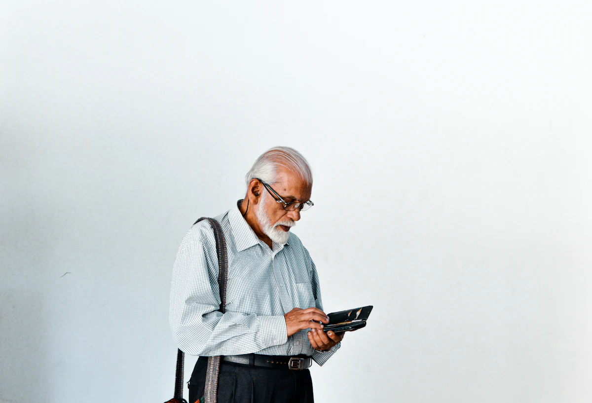 An older man checking the contents of his wallet